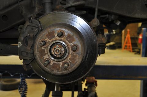 1996 Ford Bronco - Close-up of a vehicle's front brake rotor and caliper, showing signs of rust.