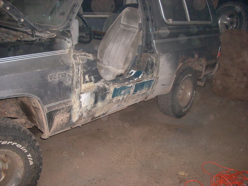 1988 Chevrolet Blazer driver's side with rust damage and repair work on rocker panel.