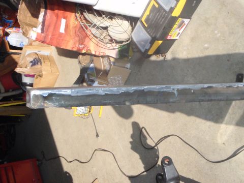 1996 Ford Bronco - A metal bumper or frame piece is shown with a white substance applied to its surface, possibly for welding or repair. Various items like to…
