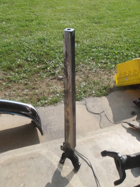 1996 Ford Bronco - A metal post with a base is standing upright on a concrete surface. To the left is a chrome bumper, and to the right is a yellow plastic co…