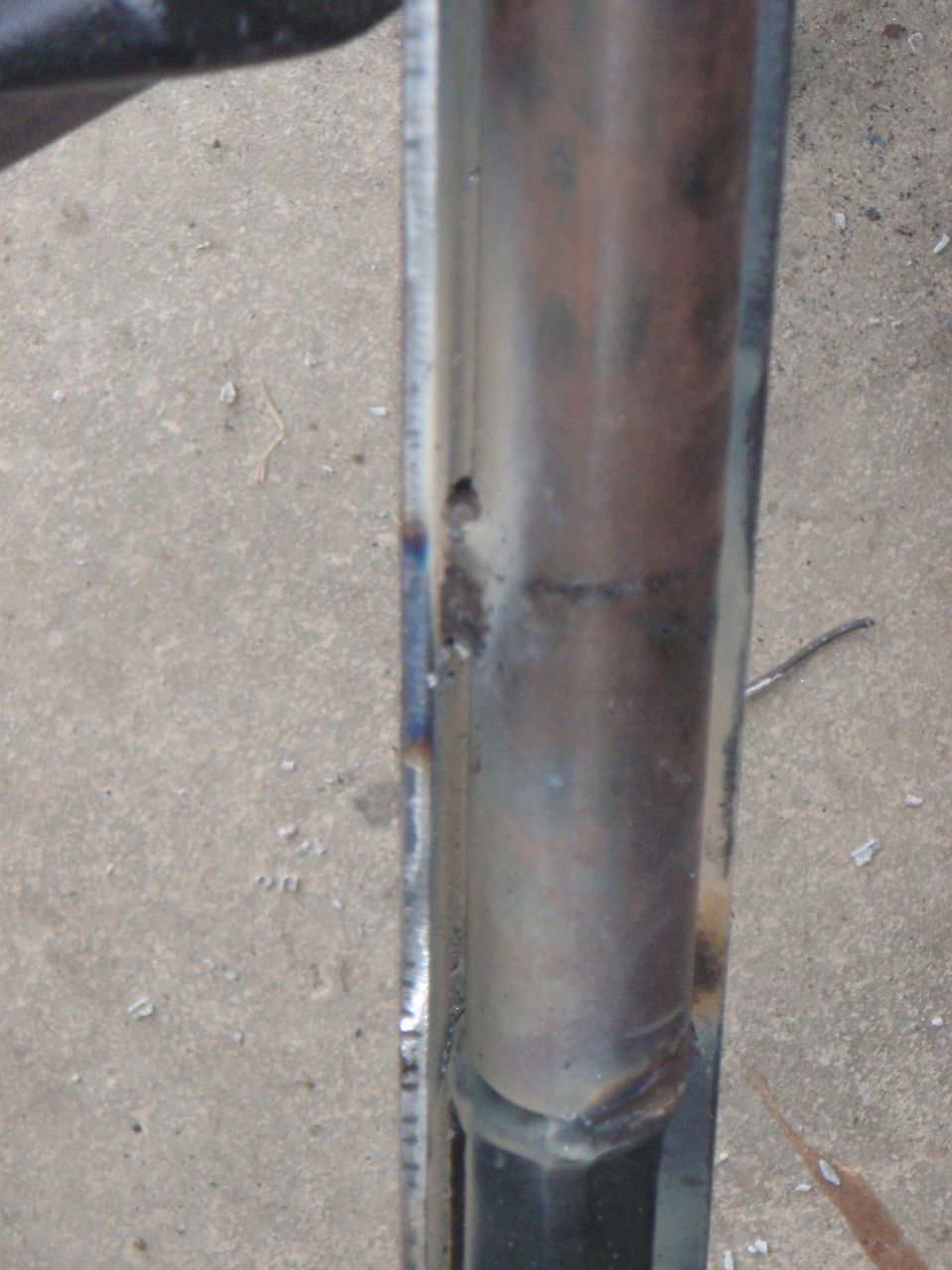 Close-up of a welded metal part on concrete