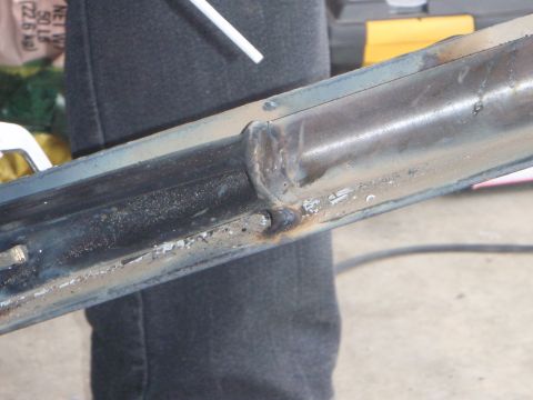 1996 Ford Bronco - A close-up view shows a welded metal component, likely part of a vehicle frame or chassis, with visible weld marks and some discoloration f…