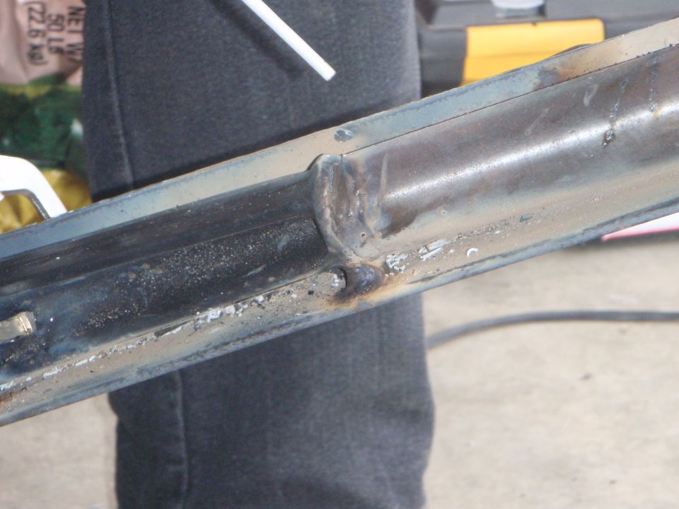 Welded metal component, possibly vehicle frame, with visible weld marks.