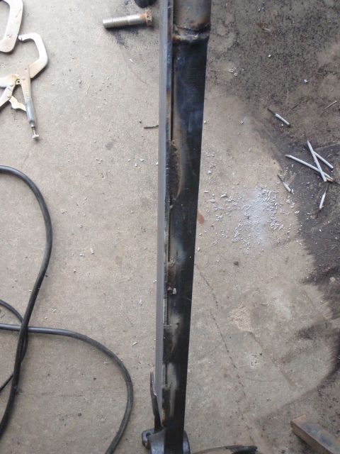 1996 Ford Bronco - A close-up view shows a metal structural component, possibly part of a vehicle frame or suspension, with visible weld marks and some surfac…