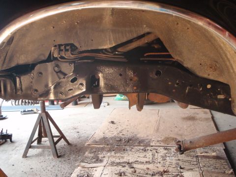 1996 Ford Bronco - A close-up view of the underside of a vehicle, focusing on the frame and suspension components. The frame appears to have been recently pai…