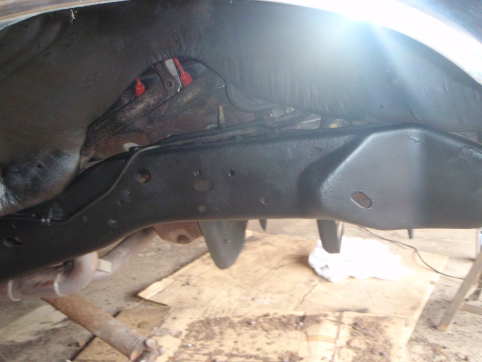 Underneath view of a vehicle frame with protective coating.