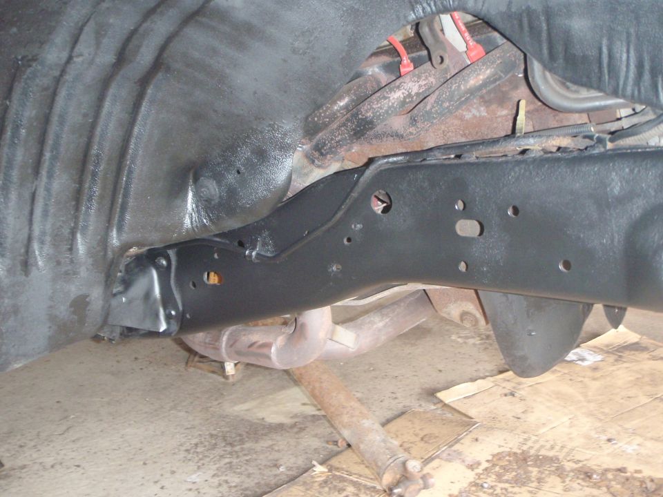 Underside view of a 1996 Ford Bronco frame and suspension components painted black.