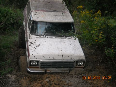 1979 Ford Bronco - This 1979 Ford Bronco is stuck deep in the mud, with only its front grille and part of the hood visible above the mire.
