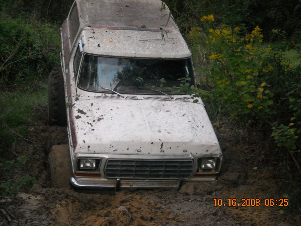 1979 Ford Bronco stuck in mud, front grille visible