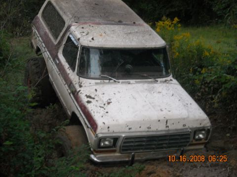 1979 Ford Bronco - This 1978 Ford Bronco is stuck deep in the mud, off-roading in a wooded area.