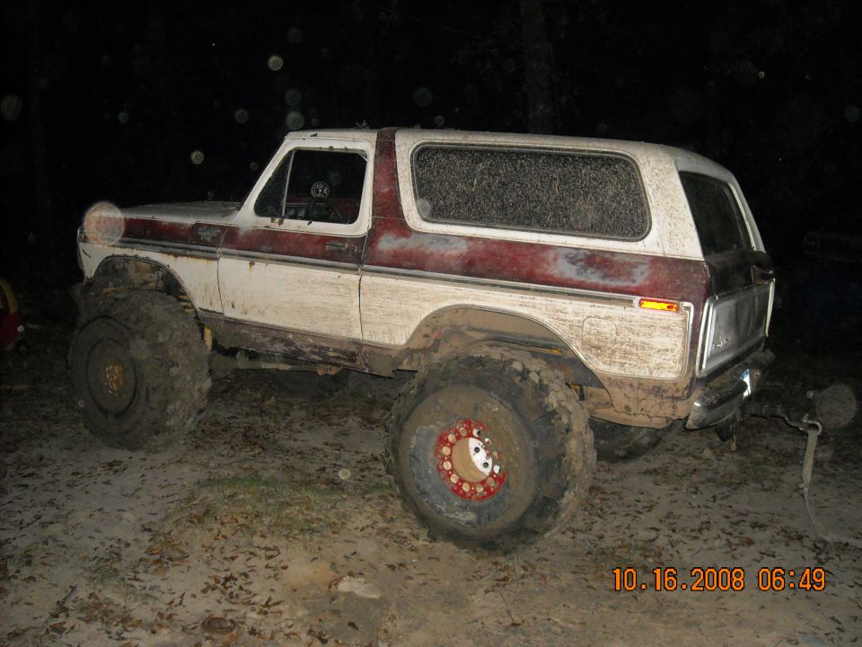 White and red 1979 Ford Bronco with large off-road tires