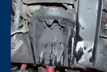 1984 Ford Bronco - Close-up of an unidentified vehicle's undercarriage, focusing on a mechanical part.