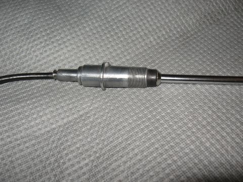 1968 Shelby GT500 - Close-up of a vehicle antenna base, showing its metallic construction and cable connection.