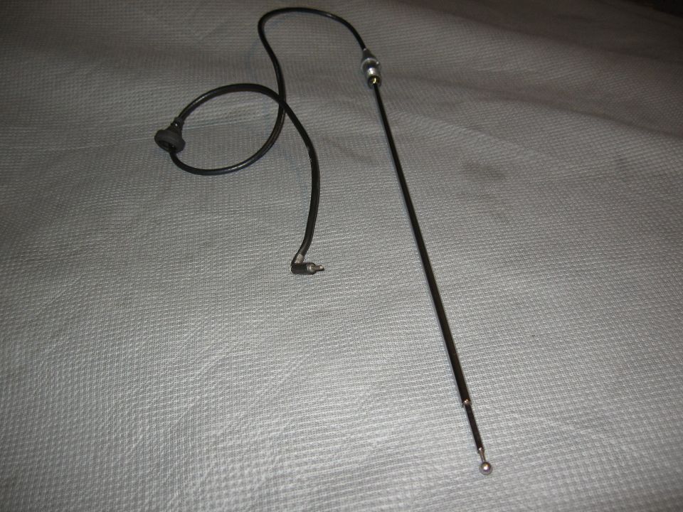 Black car antenna with coiled wire and connector