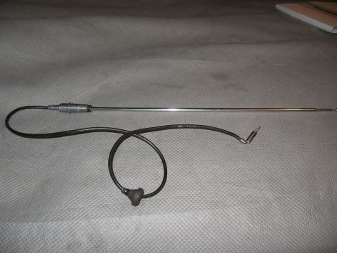 1968 Shelby GT500 - Car antenna with coiled cable and angled connector shown on a gray surface.