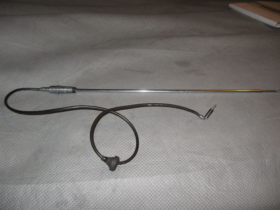 Chrome car antenna with black coiled cable and angled connector