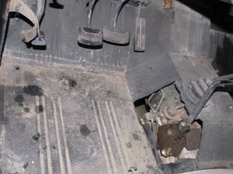 1976 Ford Bronco - Close-up view of the floorboard and pedals inside a vehicle.