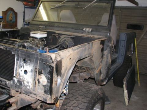 1976 Ford Bronco - Front view of a 1976 Ford Bronco showing the engine bay and front clip during a build.