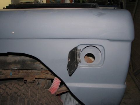 1976 Ford Bronco - Close-up of the rear fender and open fuel filler door on a 1976 Ford Bronco, ready for paint.