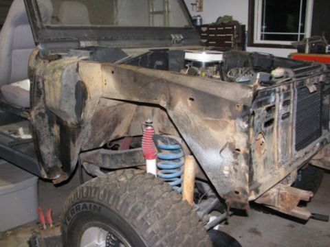1976 Ford Bronco - This 1976 Ford Bronco is undergoing repairs, with its front end disassembled to reveal the engine and suspension components.