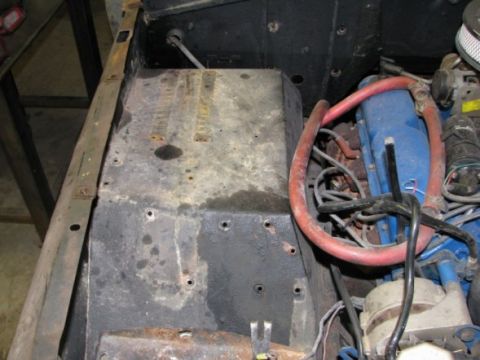 1976 Ford Bronco - Close-up view of engine components, including blue valve covers and red hoses.