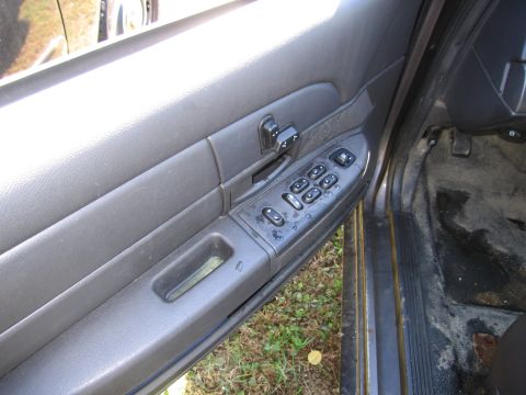 1991 Ford LTD Crown Victoria - Close-up of a car's interior door panel, showing the power window and lock controls.