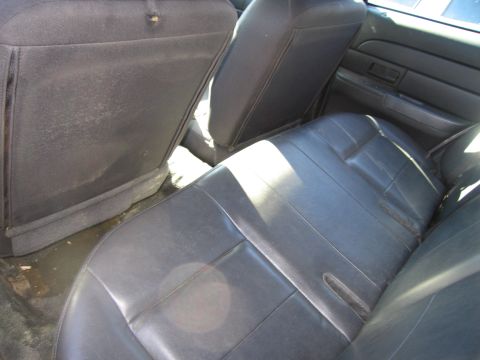 1991 Ford LTD Crown Victoria - Interior view of the rear seats and door panel of a 1991 Ford Crown Victoria LTD.