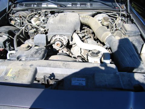 1991 Ford LTD Crown Victoria - The engine bay of a car is visible, the engine, air intake system, and coolant reservoir.