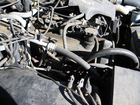 1991 Ford LTD Crown Victoria - Close-up view of the engine compartment, showing various hoses and wiring.