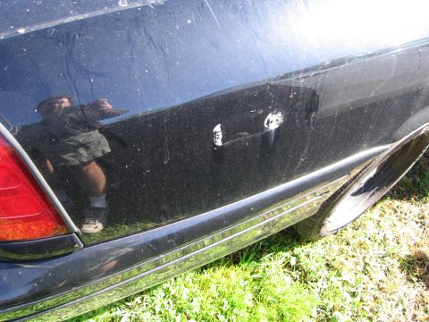 1991 Ford LTD Crown Victoria - Side view of a 1991 Ford Crown Victoria LTD, focusing on the rear door and chrome trim.