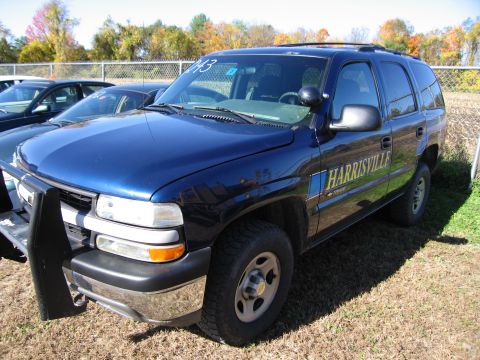 1991 Ford LTD Crown Victoria - A blue SUV with a push bar and police markings is parked outdoors.