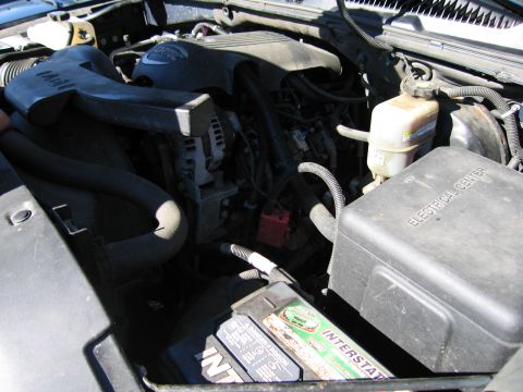 1991 Ford LTD Crown Victoria - Close-up of a vehicle's engine bay, showing the battery and fuse box.