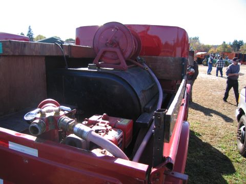 1991 Ford LTD Crown Victoria - Close-up view of the equipment mounted in the bed of a red fire truck.
