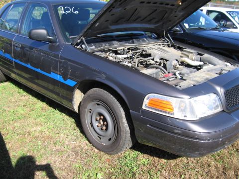 1991 Ford LTD Crown Victoria - Dark gray 1991 Ford Crown Victoria LTD with hood open, parked on grass. Another vehicle is in the background.