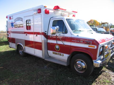 1991 Ford LTD Crown Victoria - This ambulance, marked 'RESCUE 3', is seen from a three-quarter front view against a clear sky.