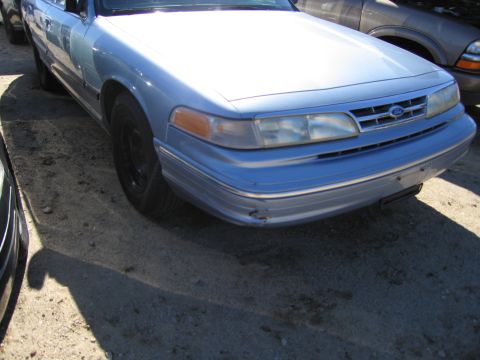 1991 Ford LTD Crown Victoria - Front view of a light blue Ford Crown Victoria showing its grille and headlights.