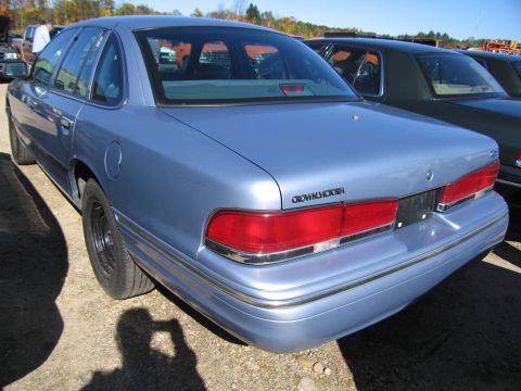 1991 Ford LTD Crown Victoria - Rear view of a 1991 Ford Crown Victoria LTD, showing its distinctive taillights and chrome bumper trim.