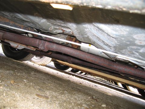 1991 Ford LTD Crown Victoria - Underside view of a vehicle, revealing the exhaust system and tires.