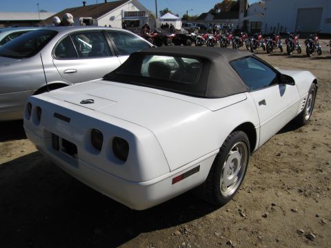 1991 Ford LTD Crown Victoria - White 1991 Chevrolet Corvette convertible parked outdoors with a silver sedan beside it.