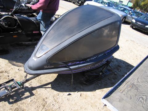 1991 Ford LTD Crown Victoria - A Ski-Doo snowmobile sits outdoors with a large tinted windshield and purple graphics.