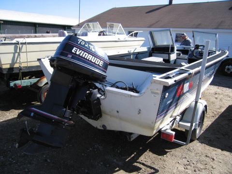 1991 Ford LTD Crown Victoria - An Evinrude outboard motor is attached to the back of a boat on a trailer.