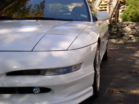 1996 Ford Probe - Front view of a white 1996 Ford Probe parked outdoors with autumn leaves on the ground.