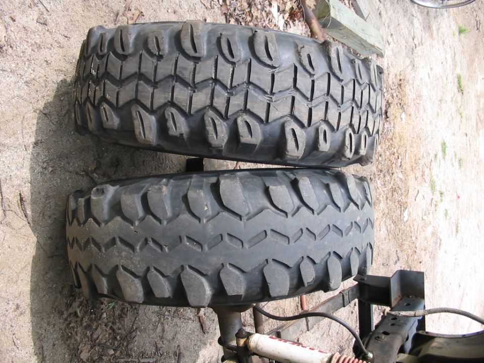 Two stacked off-road tires with aggressive tread patterns