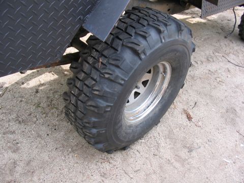 1985 Ford Bronco - A close-up view of a off-road tire and part of the vehicle's bodywork.