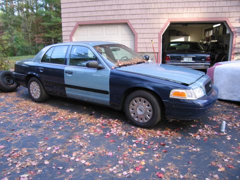 1991 Ford LTD Crown Victoria - A 1991 Ford Crown Victoria LTD is seen from a three-quarter front angle, parked outdoors.
