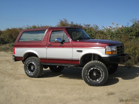 1996 Ford Bronco - This lifted 1996 Ford Bronco features a two-tone paint scheme and aggressive off-road tires, ready for adventure.