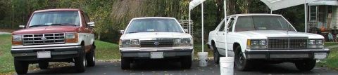 1991 Ford LTD Crown Victoria - A 1991 Ford Crown Victoria LTD is parked in the middle of three vehicles.
