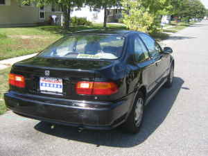 1996 Dodge 1500 - Rear view of a black sedan, possibly a 1995 model, with a prominent SUPERMOTORS.NET watermark.