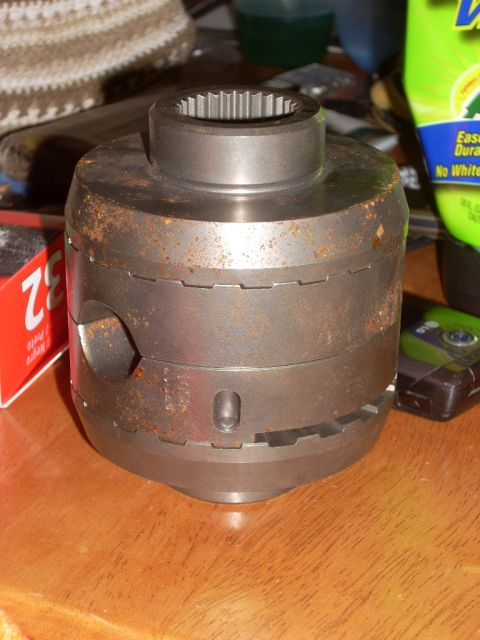 1988 Chevrolet Blazer - A rusty differential locker sits on a wooden table next to a red box and a bottle of cleaner.