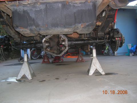 1985 Ford Bronco - The rear axle assembly of a vehicle is shown on jack stands, undergoing maintenance or modification.